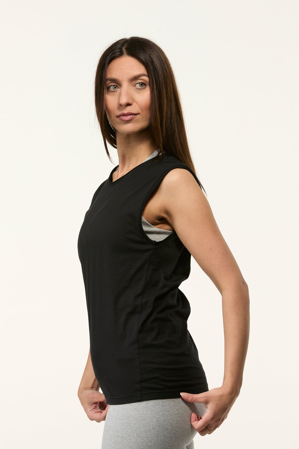 Side view of the Slim Fit Tank in black with a flattering slim fit and sleeveless shape