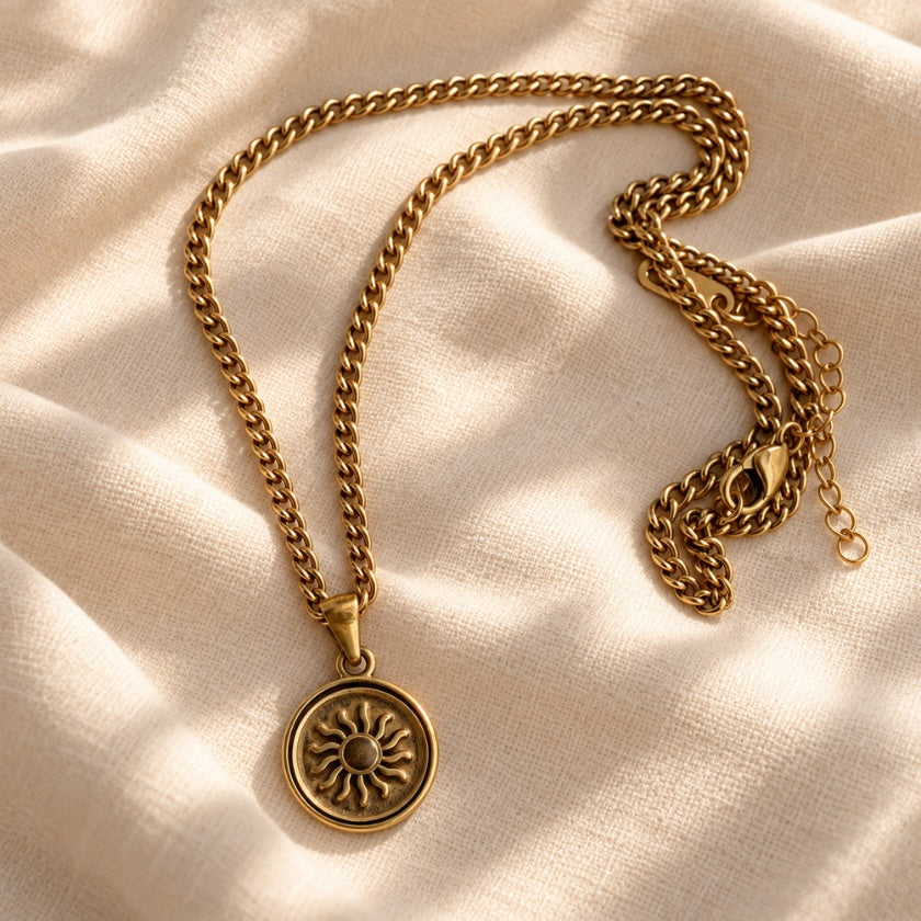 Solar Radiance gold-plated stainless steel necklace with round sun medallion pendant.