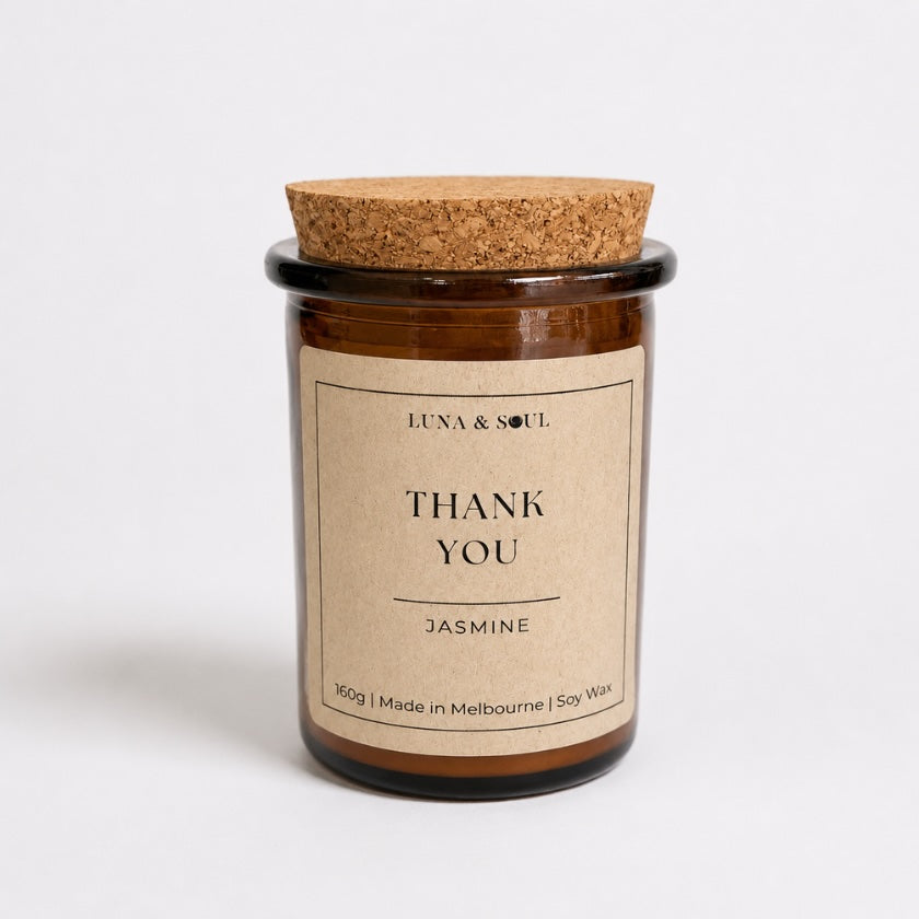 Luna &amp; Soul Thank You soy candle in amber glass with natural cork lid.
