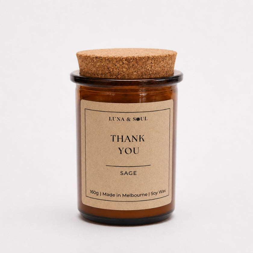 Luna & Soul Thank You soy candle in amber glass with natural cork lid.