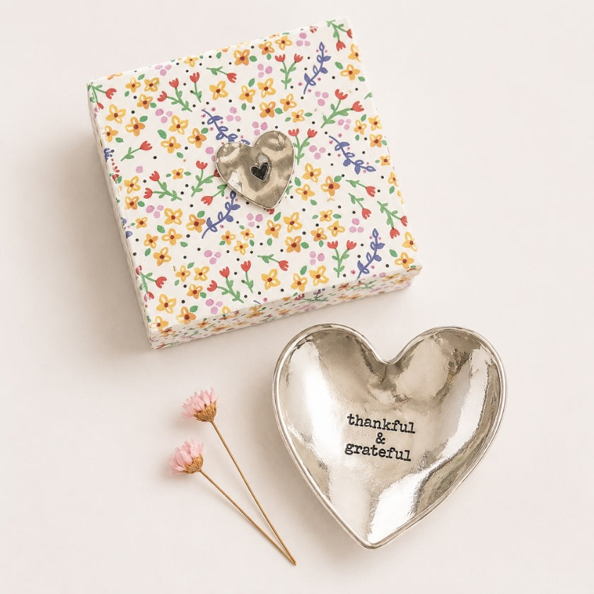 Silver heart shaped trinket dish with “thankful &amp; grateful” quote, styled with floral gift box packaging.