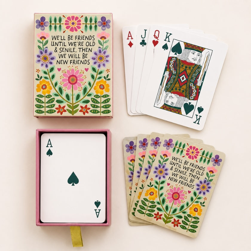 Floral themed playing cards with colourful flower illustrations and “We’ll be friends until we’re old and senile, then we will be new friends” quote on decorative card backs and matching storage box.