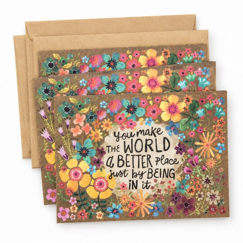 Floral greeting card with colourful botanical illustrations and “You make the world a better place just by being in it” quote.