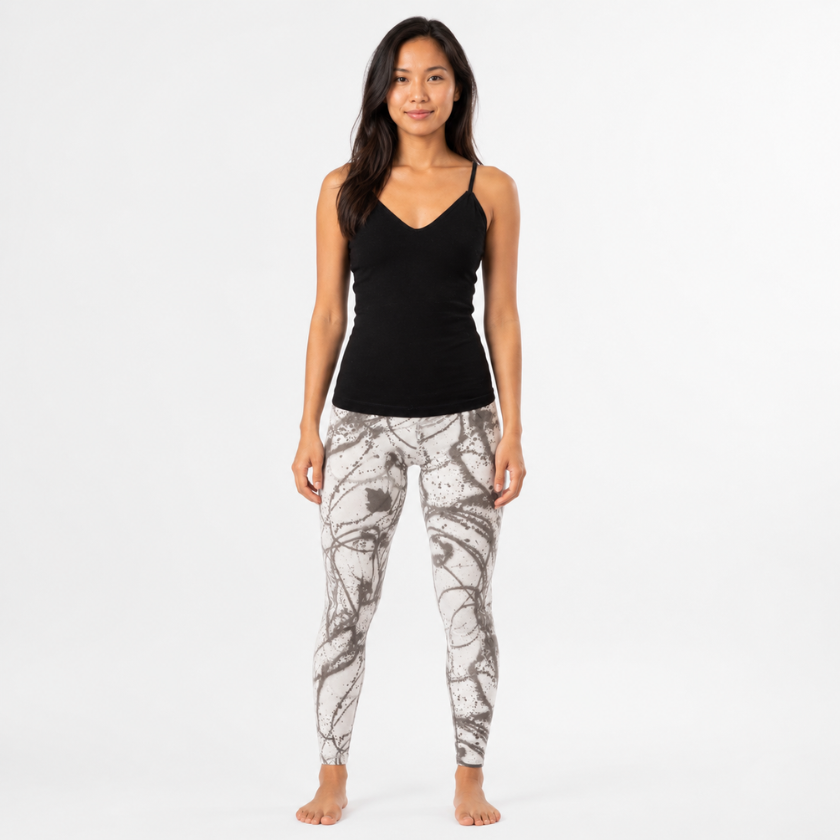 Southeast Asian model wearing the Luna &amp; Soul black zigzag strap top with grey scribble print yoga leggings, shown from the front on a clean studio background.