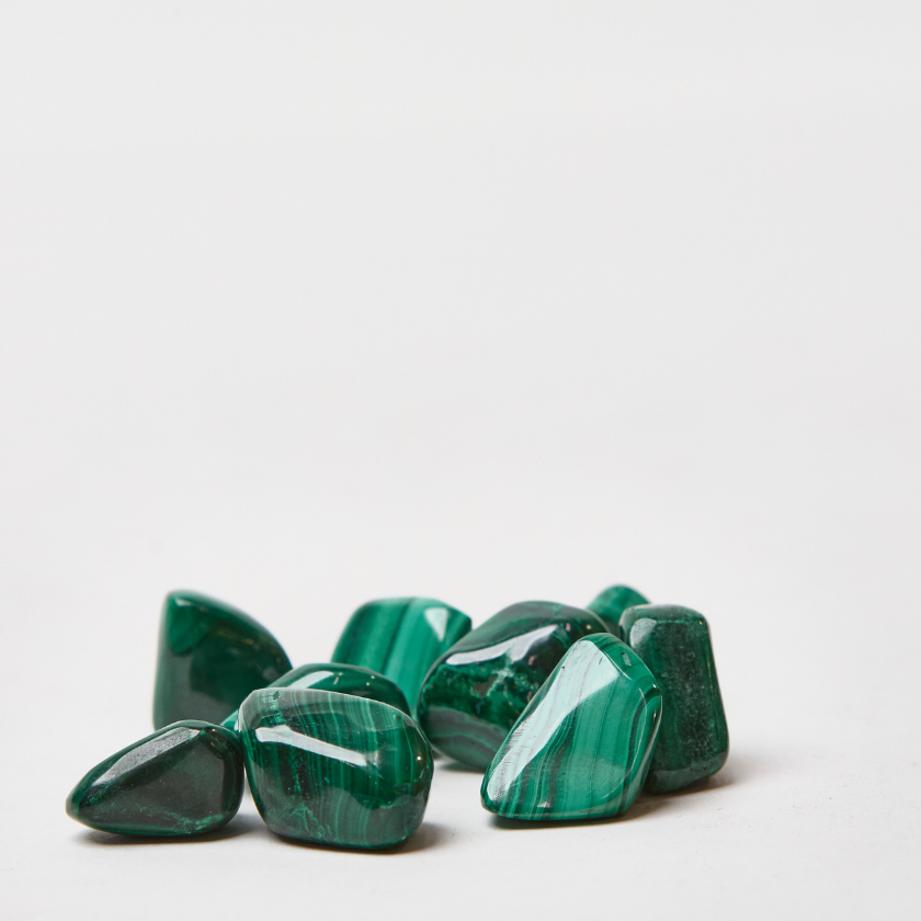 Malachite tumble stone crystal in deep green tones for transformation and emotional healing