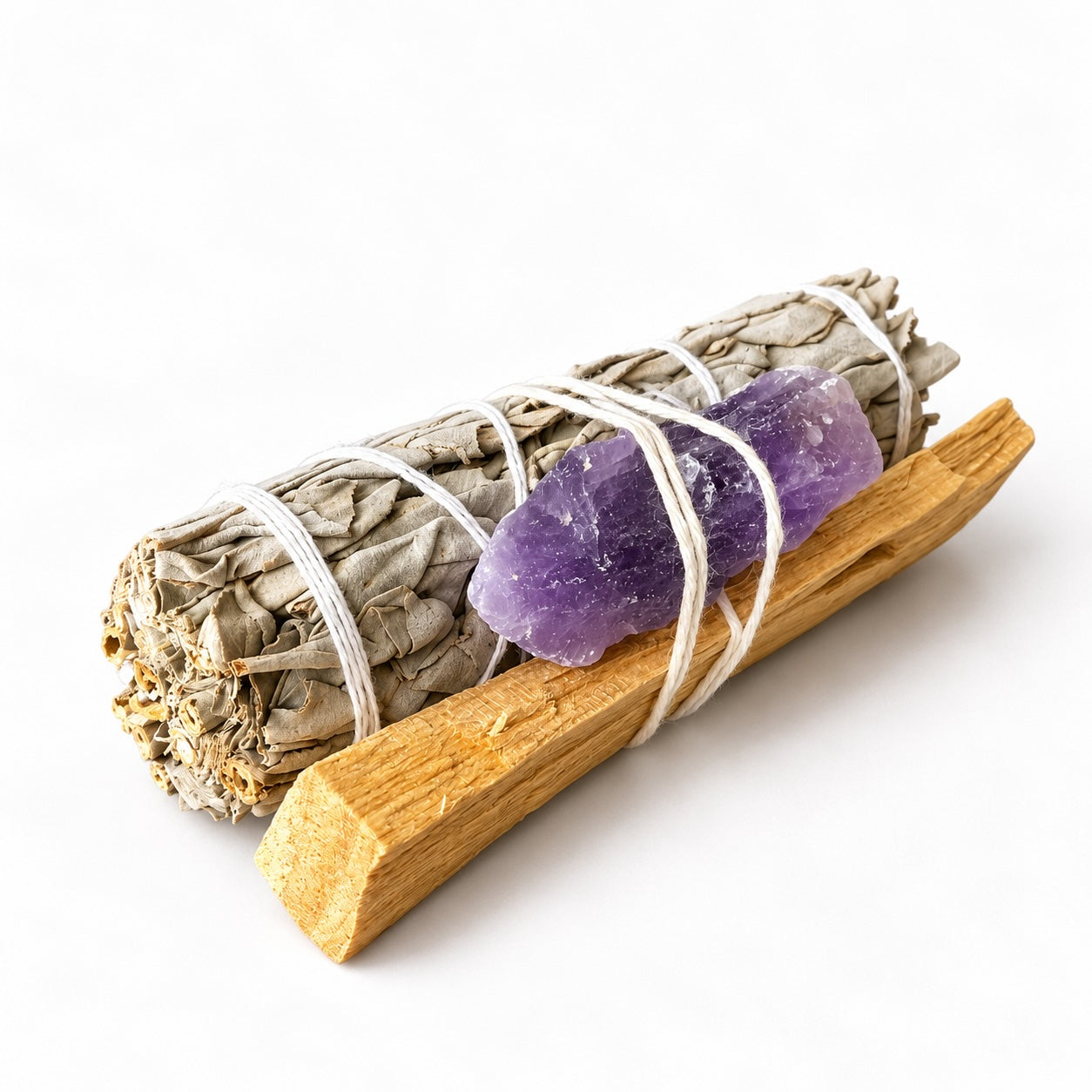 Mini White Sage smudge stick kit with Palo Santo wood and a purple Amethyst crystal, tied together with white string.