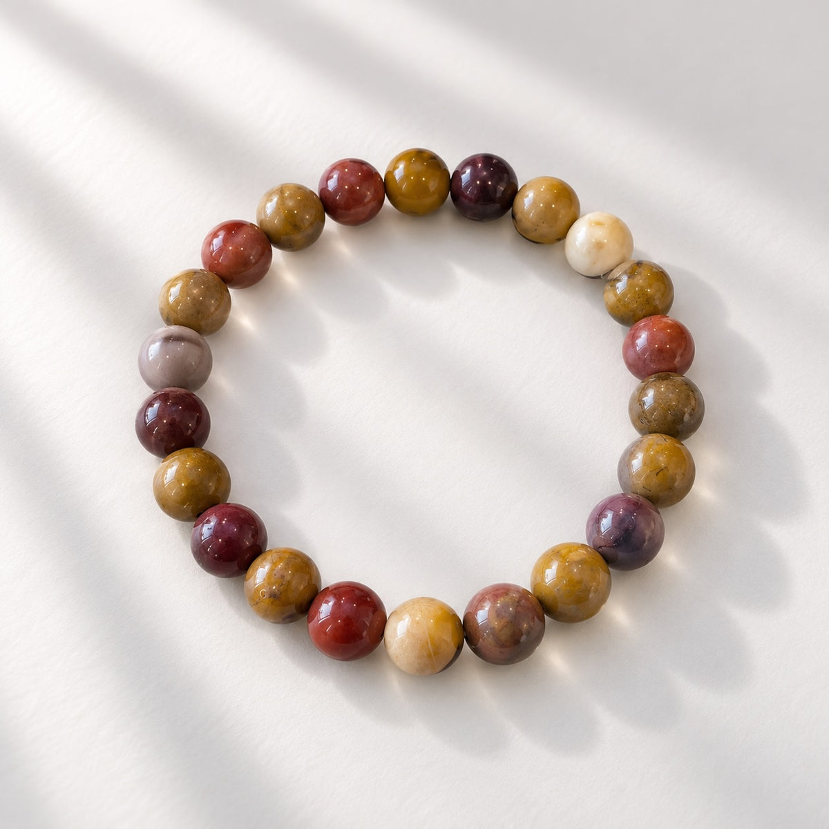 Mookaite beaded bracelet with 8 mm round beads in earthy mixed tones. 