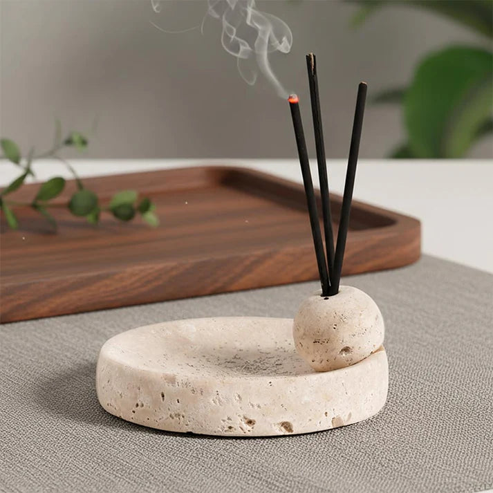 Natural stone incense holder set with ash catching tray and three incense sticks, styled on a neutral table with soft smoke.
