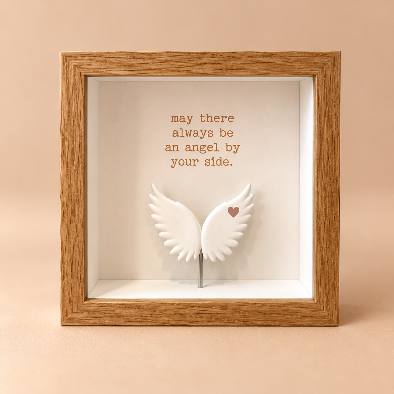 Square oak finish 3D shadowbox frame with the quote “may there always be an angel by your side” above raised white angel wings.
