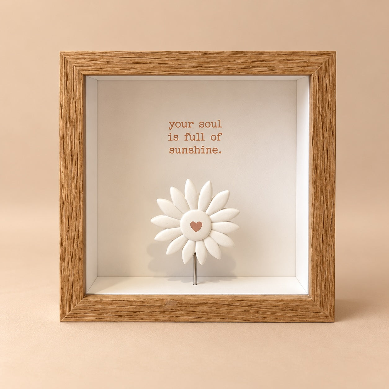 Square 3D shadowbox picture frame with an oak wood finish, “your soul is full of sunshine” quote and a raised white daisy flower figurine with a heart centre.