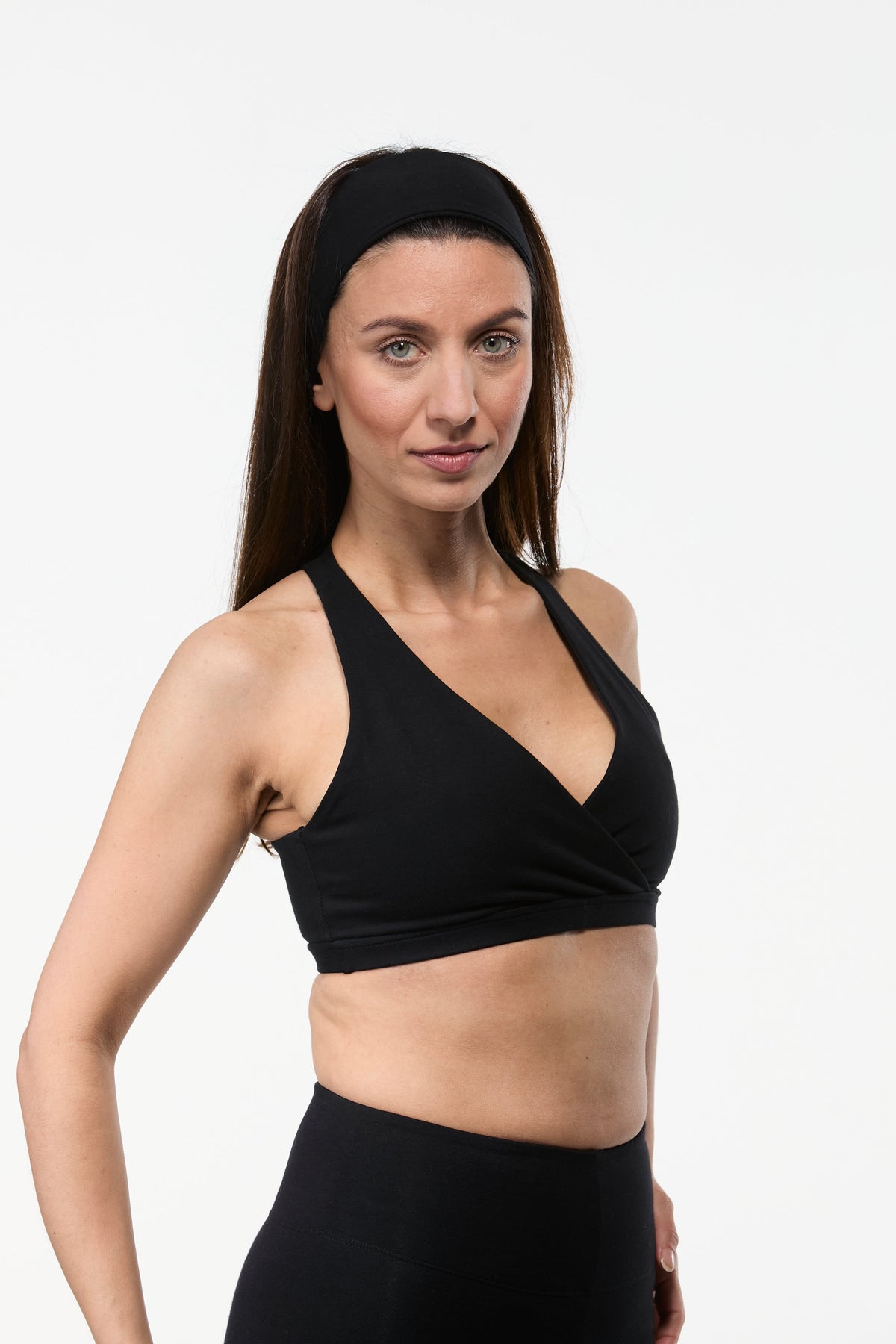 Black cotton yoga sports bra with wrap front design offering feminine coverage and supportive fit