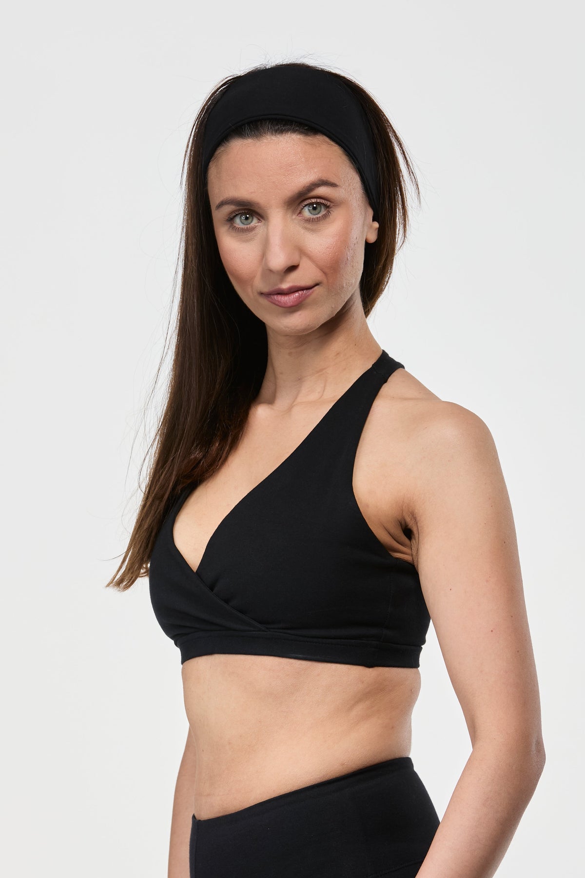 Model wearing black cotton yoga sports bra designed for supportive movement and everyday comfort