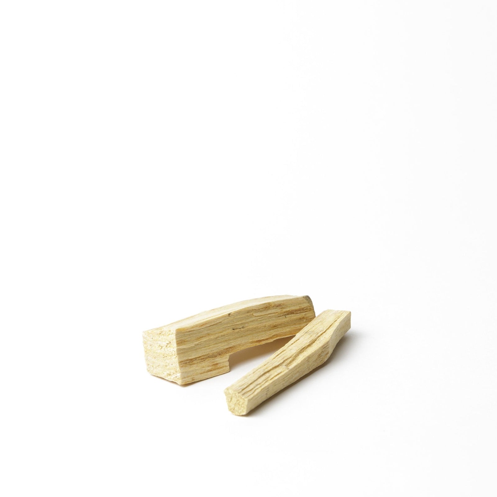 Sustainably sourced palo santo holy wood sticks for cleansing and intention setting, photographed on a clean white background.