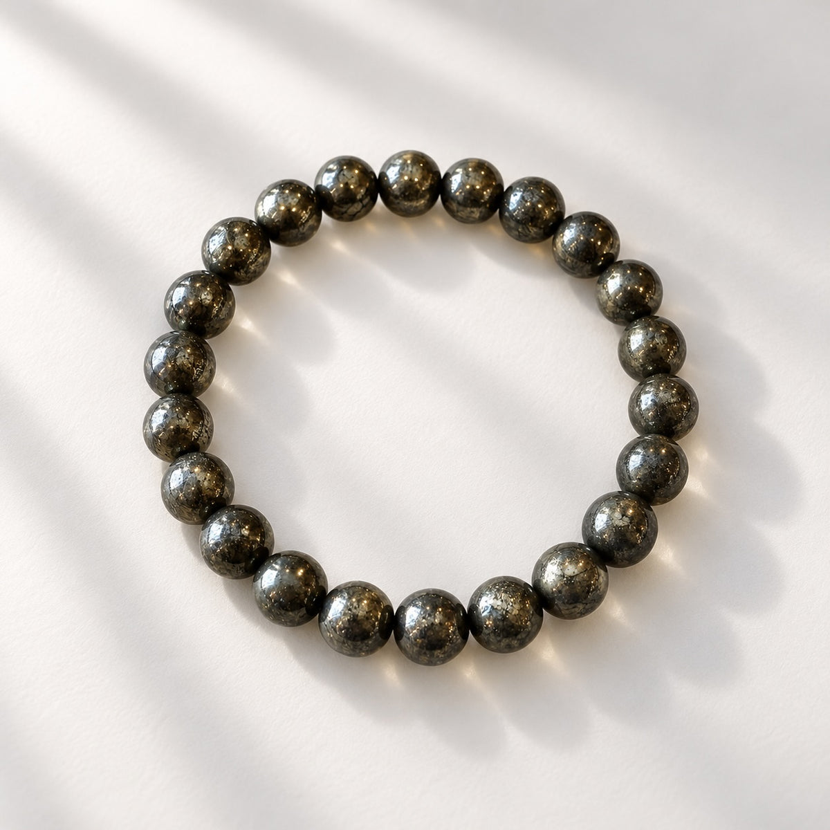 Provisional: Pyrite beaded bracelet featuring 8 mm round metallic gold tone beads.