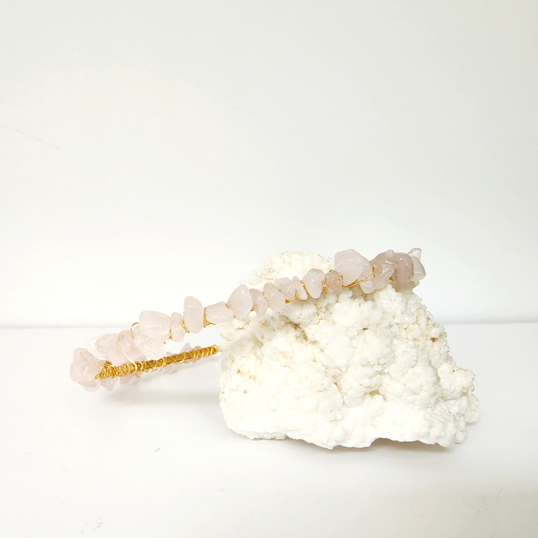 Rose quartz crystal chip headband with gold tone wire wrapping, pale pink gemstone accessory for self love and heart energy.