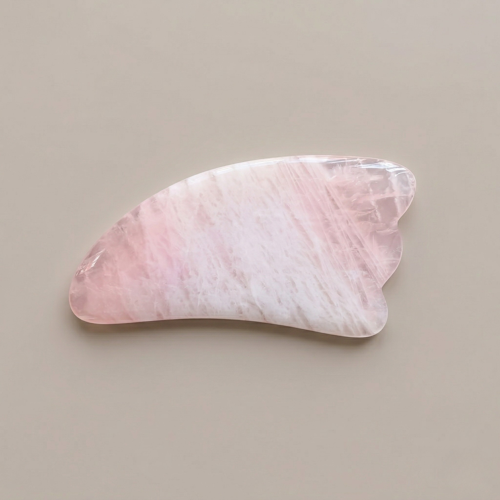 Natural rose quartz gua sha facial massage tool for skincare and lymphatic drainage
