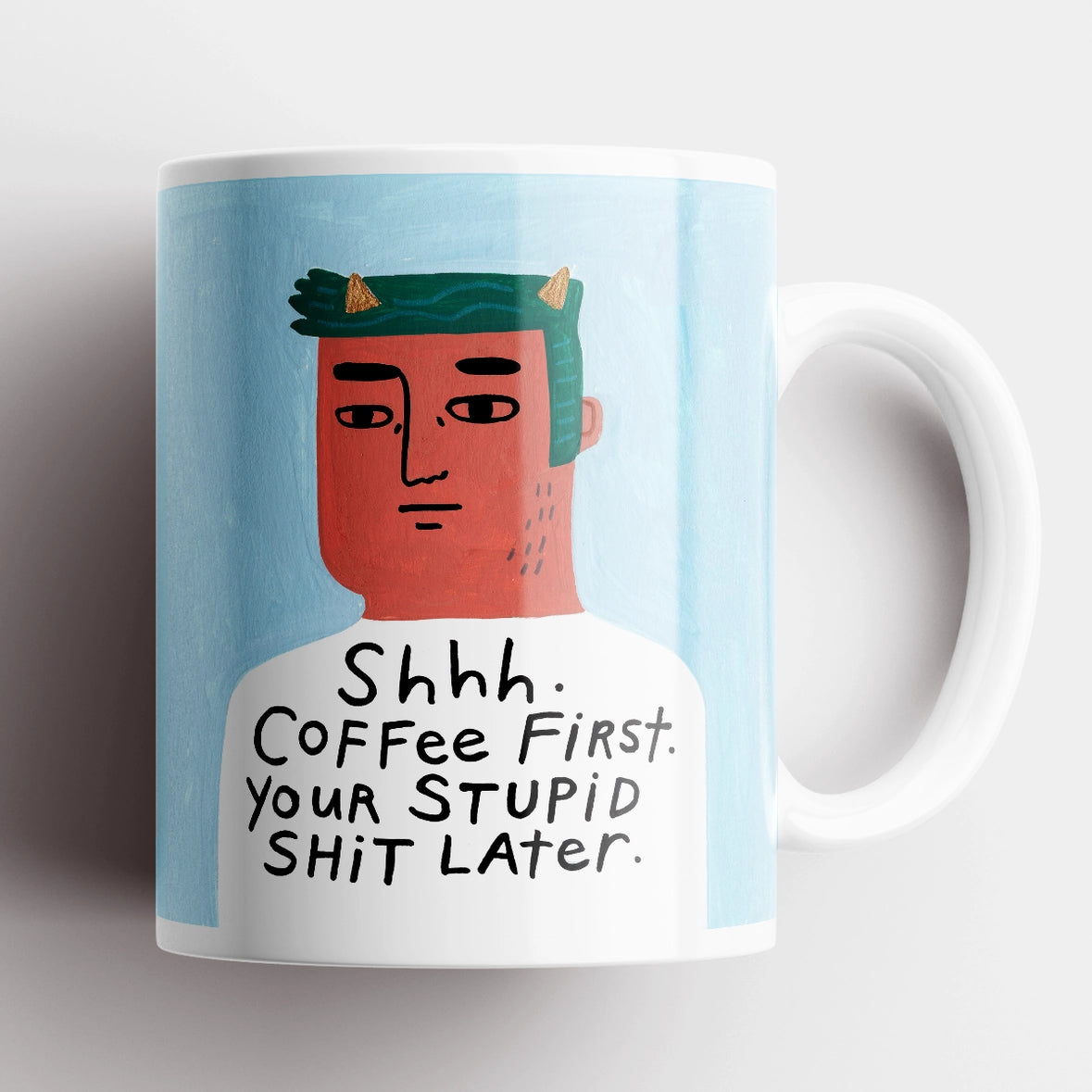 Shhh Coffee First Grumpy Bastard Mug – funny ceramic mug with illustrated man on blue background.