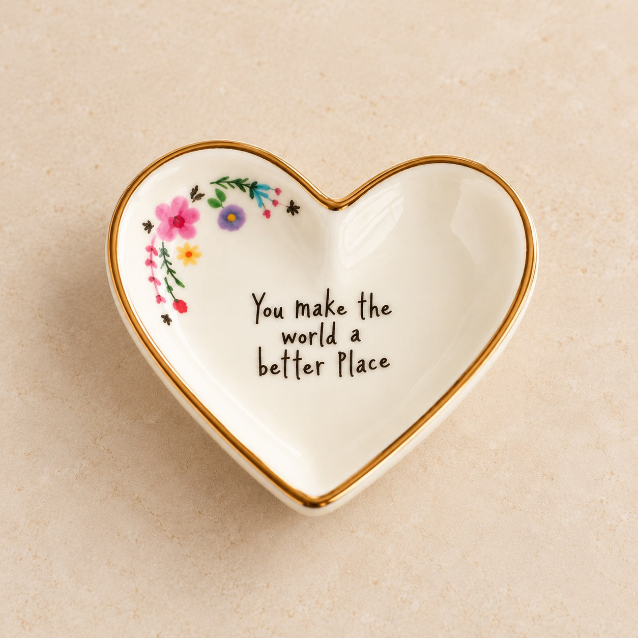 Small ceramic heart trinket dish with a gold rim, floral details and an uplifting message. A thoughtful gift for someone special.