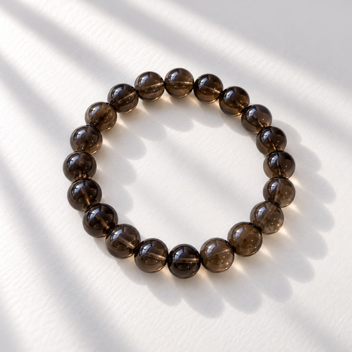 Smokey Quartz beaded bracelet with 10 mm round beads in smoky brown to grey tones.
