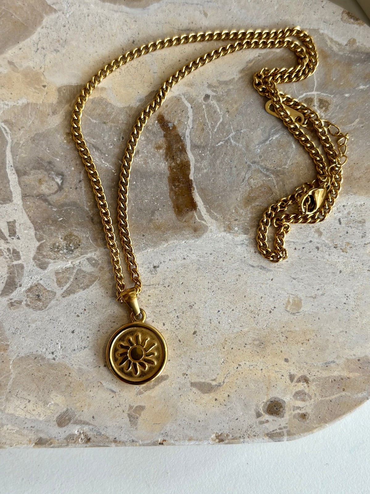 Golden stainless steel necklace symbolising vitality and renewal