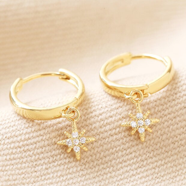 Gold starburst huggie earrings with crystal detailing