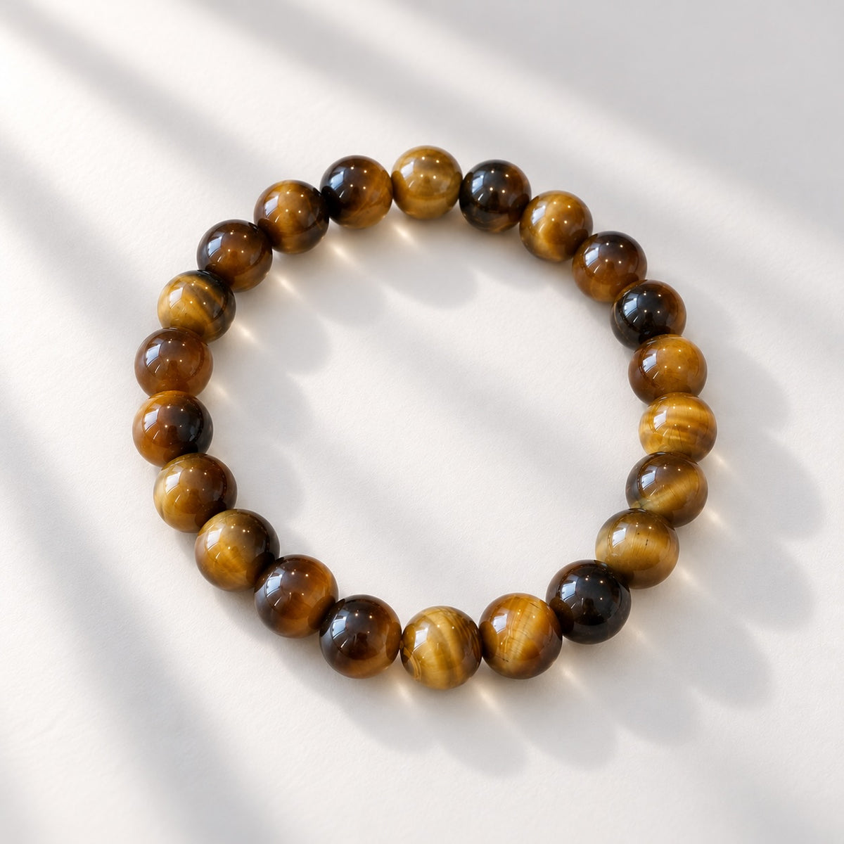 Tiger Eye beaded bracelet featuring 8 mm round beads with golden brown tones and darker banding. 