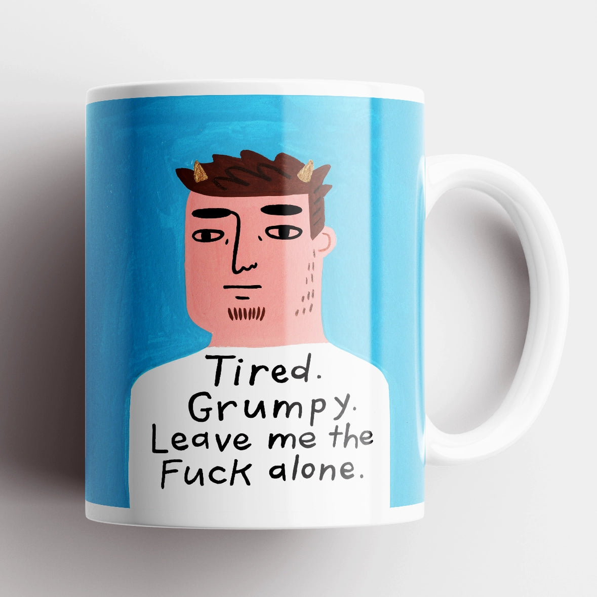 Tired Grumpy Leave Me the F** Alone Grumpy Bastard Mug* – funny ceramic mug with illustrated man on blue background.