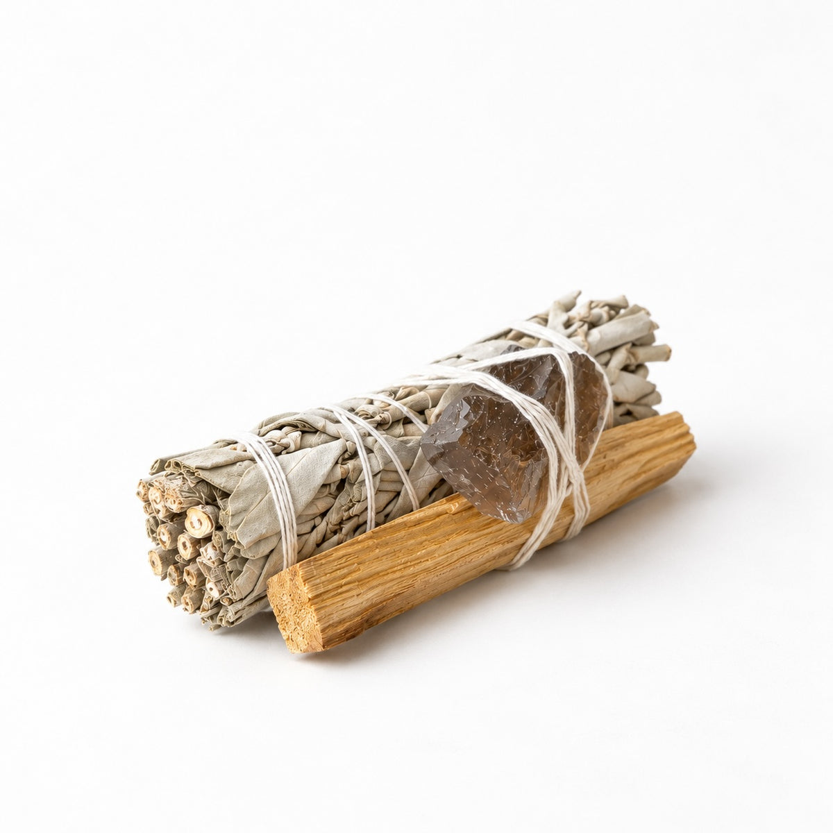 White sage smudge stick tied with Palo Santo wood and smoky quartz crystal in Luna &amp; Soul ritual kit.