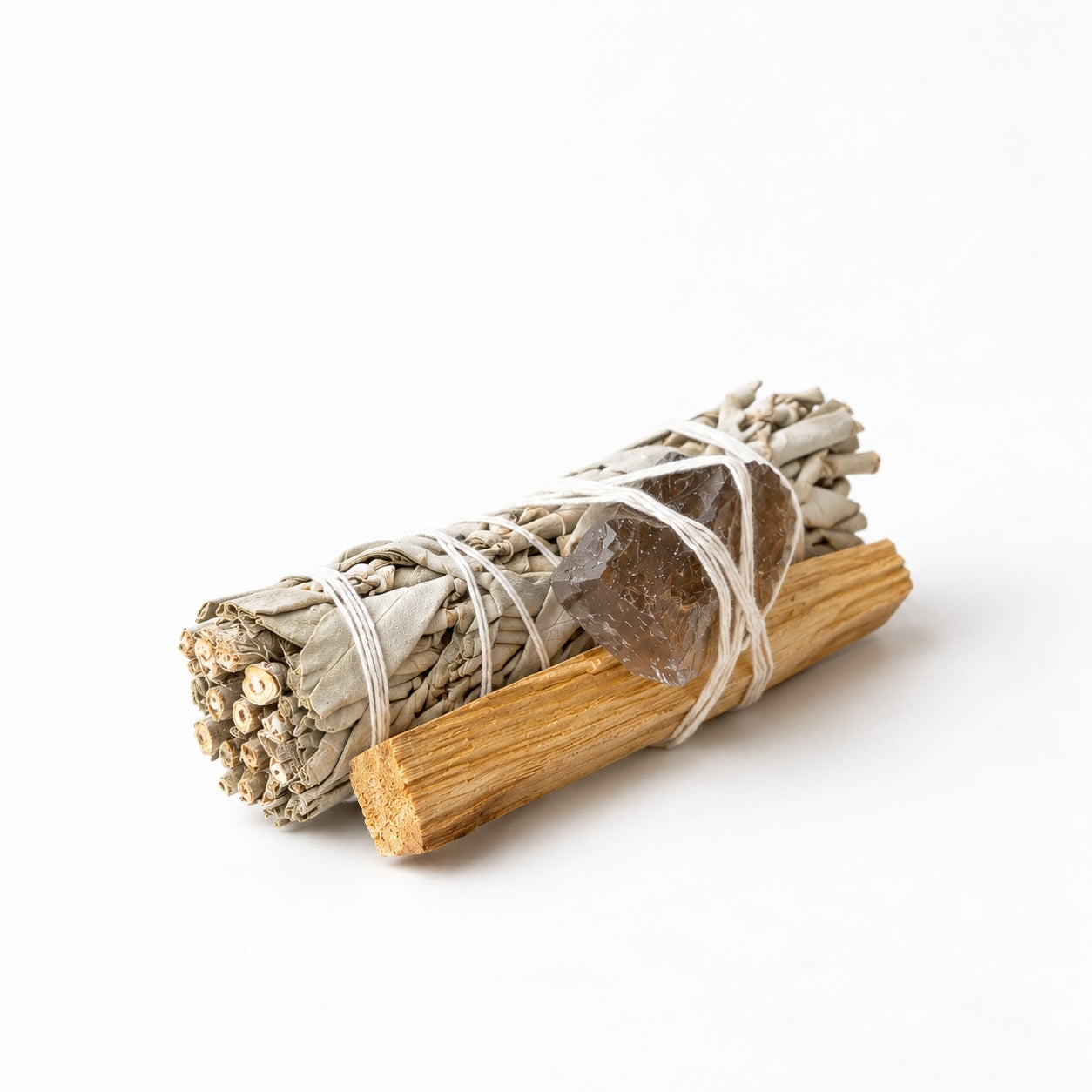 White sage smudge stick tied with Palo Santo wood and smoky quartz crystal in Luna & Soul ritual kit.
